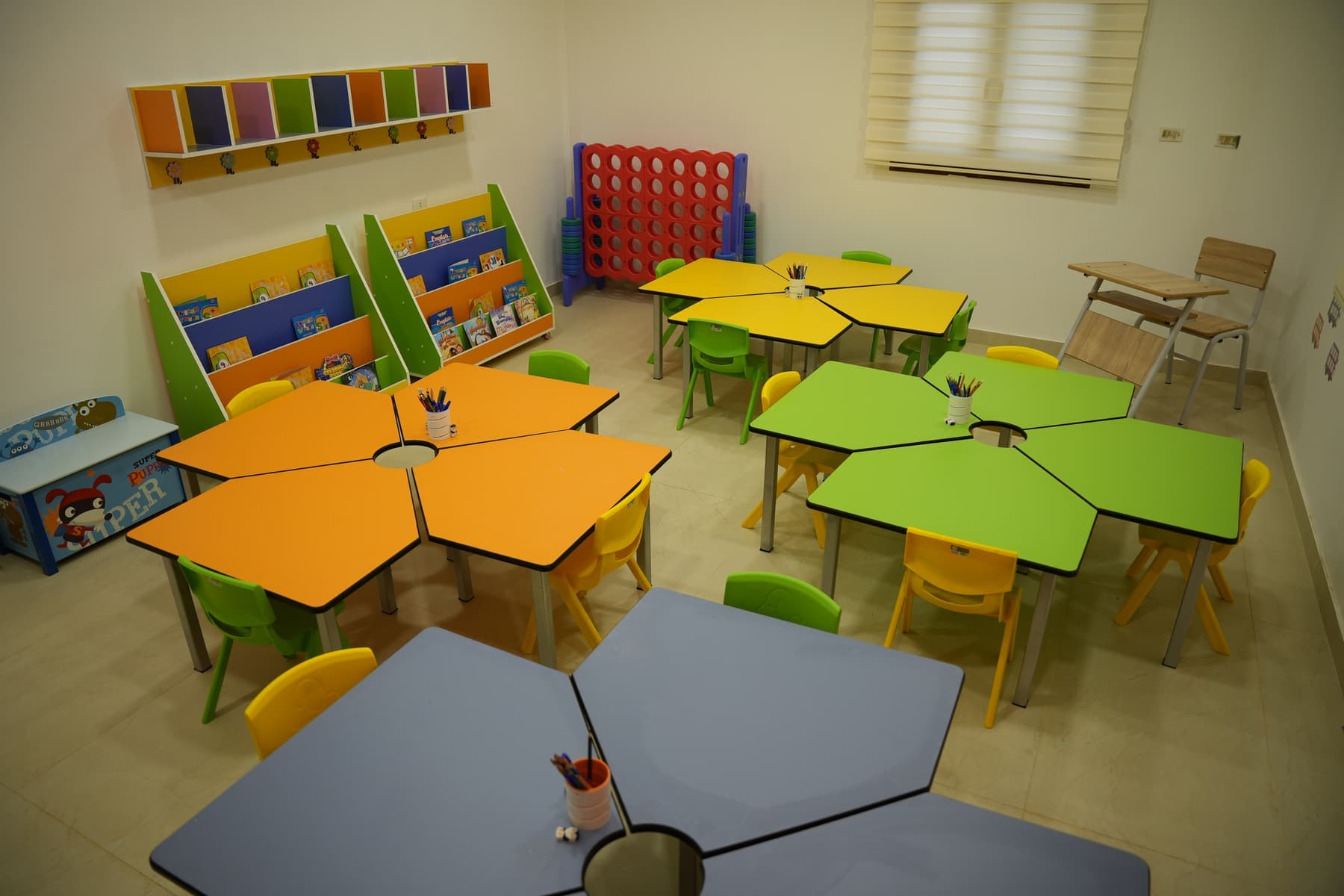 An Early Years classroom, with hexagonal tables grouped for shared work