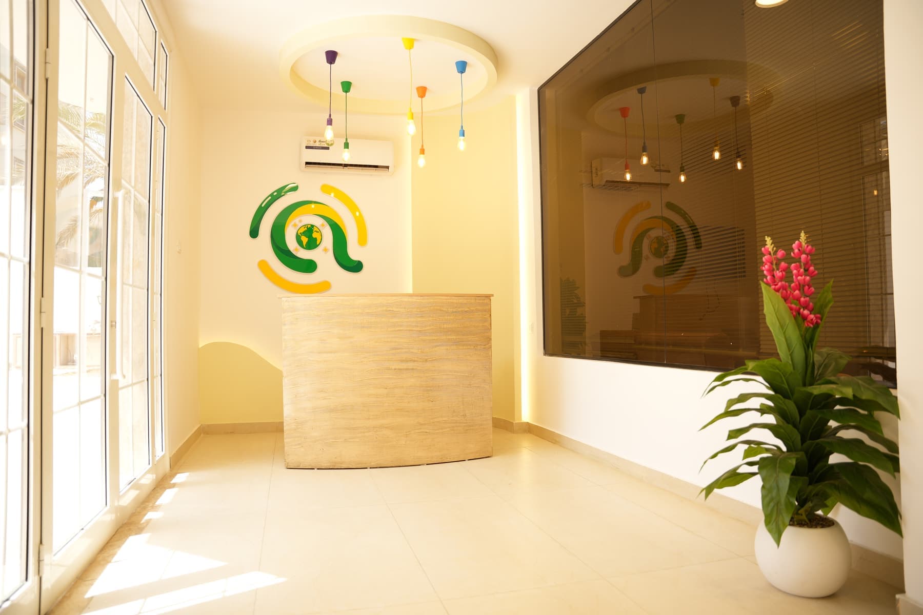 The school reception, with the Academia mark on the wall behind the desk